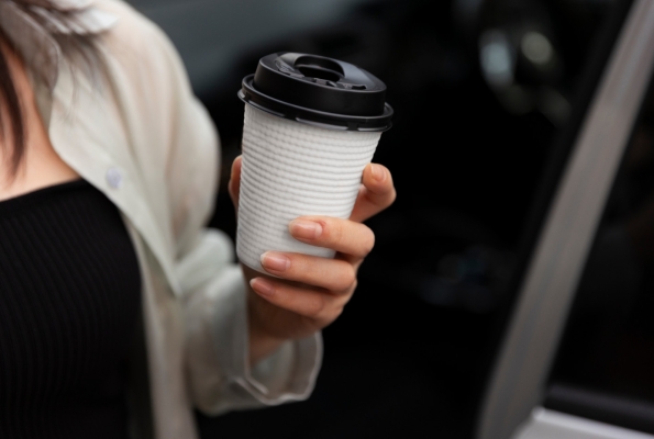 0001_woman-having-cup-coffee-with-her-electric-car_1689581645-a2f43eda6f67ead047d67710530a65d0.jpg